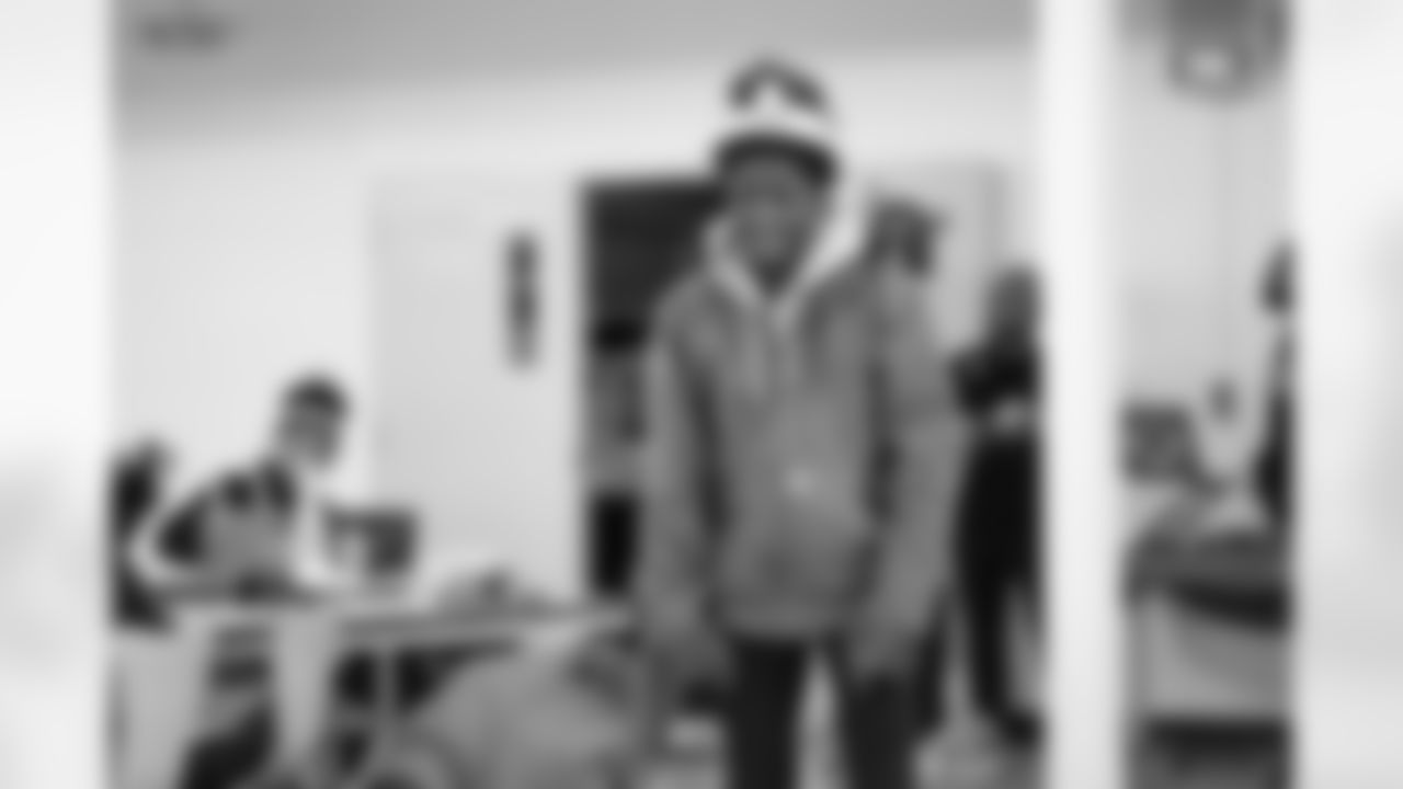 A student smiling while playing cornhole during the Presents from the Pride event at Detroit Lions Academy on Dec. 16, 2025 in Detroit. (Izzy Rincon/Detroit Lions)