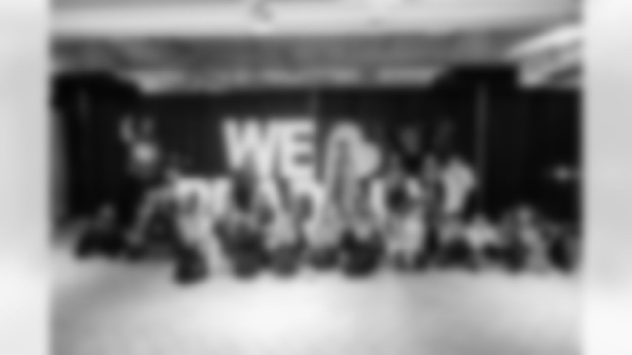 Students take a photo with Detroit Lions Mascot Roary and Lions Legend Eric Stocz (82) during the One Pride Literacy Fest at Ford Field on Oct. 28, 2025 in Detroit. (Steven Stark/Detroit Lions)