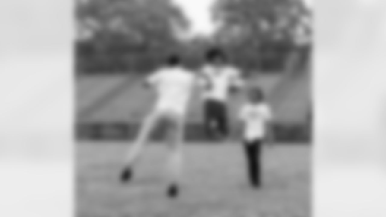 Detroit Lions edge rusher Ahmed Hassanein (61) and a student during Field Day at Detroit Lions Academy on June 6, 2025 in Detroit. (Izzy Rincon/Detroit Lions)
