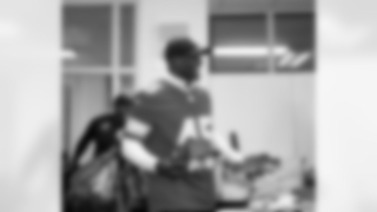 Lions Legend Cyrill Weems (45) walking into a classroom with presents in hand during the Presents from the Pride event at Detroit Lions Academy on Dec. 16, 2025 in Detroit. (Izzy Rincon/Detroit Lions)