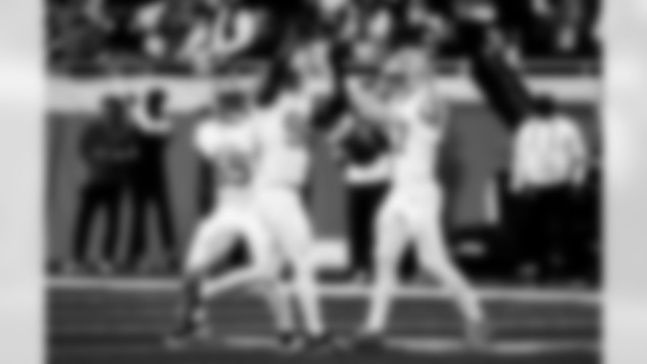 Detroit Lions linebacker Derrick Barnes (55), Detroit Lions edge rusher Al-Quadin Muhammad (96), and Detroit Lions edge rusher Aidan Hutchinson (97) celebrate after a sack during an NFL football game against the Dallas Cowboys on Thursday, Dec. 4, 2025 in Detroit. (Jeff Nguyen/Detroit Lions via AP)