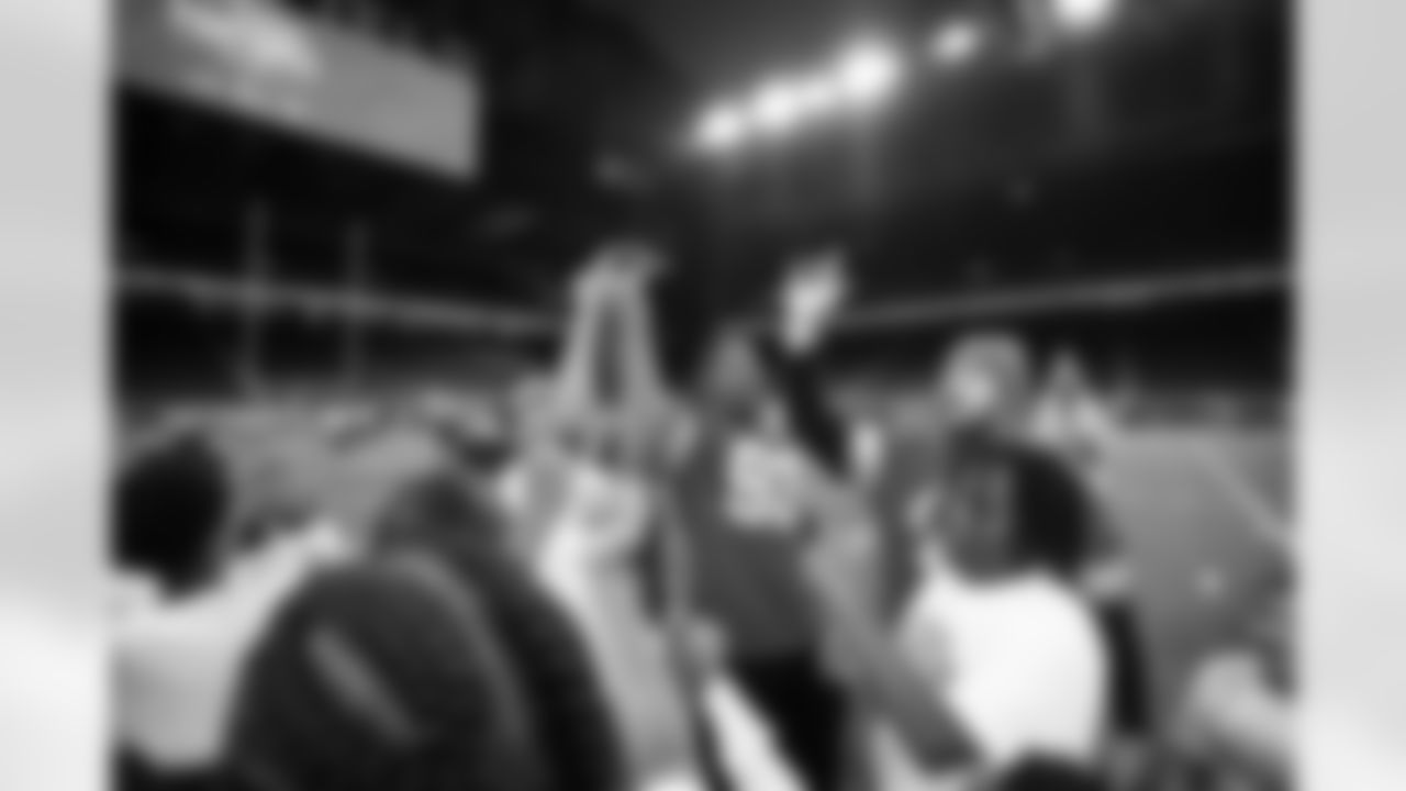 Detroit Lions edge rusher Al-Quadin Muhammad (96) and Detroit Lions long snapper Hogan Hatten (49) breaking the group down during the Inspire Change Football Clinic at Ford Field on Dec. 9, 2025 in Detroit. (Izzy Rincon/Detroit Lions)