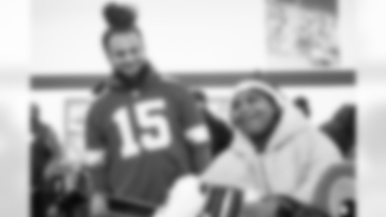 Detroit Lions linebacker Grant Stuard (15) and a participant smiling during Shop with a Lion at Meijer on Dec. 8, 2025 in Detroit. (Izzy Rincon/Detroit Lions)