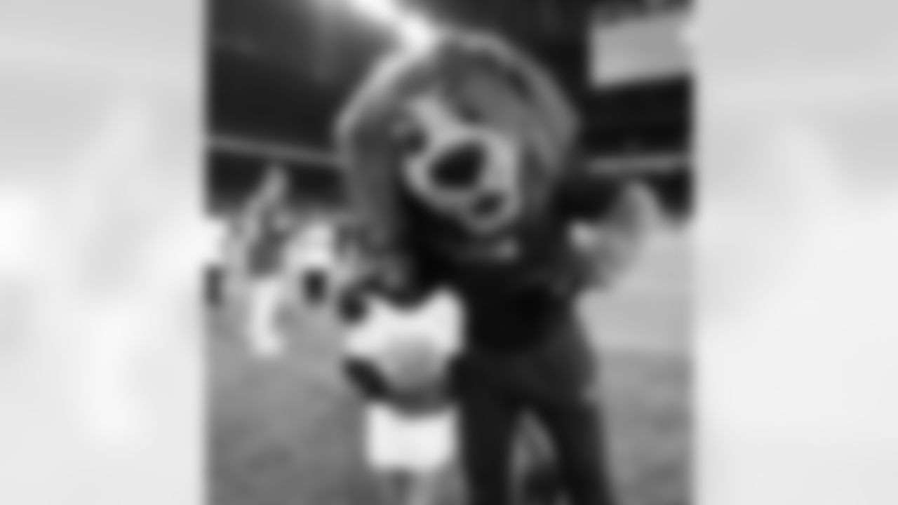 Detroit Lions Mascot Roary and a participant pose for a photo during the Inspire Change Football Clinic at Ford Field on Dec. 9, 2025 in Detroit. (Izzy Rincon/Detroit Lions)