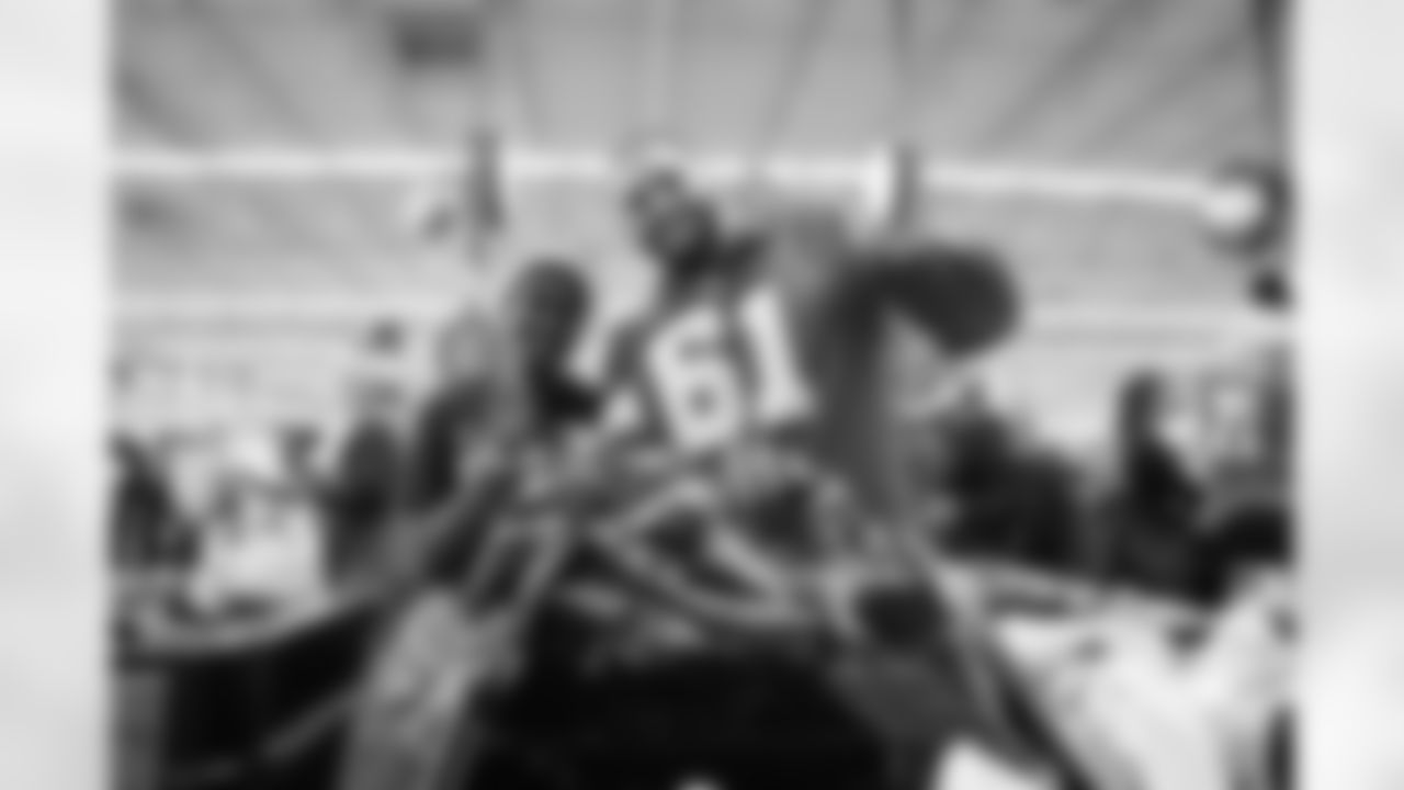 Detroit Lions edge rusher Ahmed Hassanein (61) and a participant pose for a photo during Shop with a Lion at Meijer on Dec. 8, 2025 in Detroit. (Izzy Rincon/Detroit Lions)