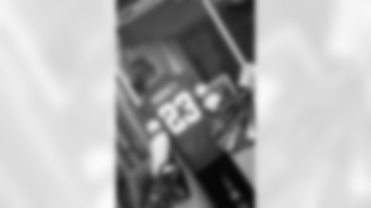 Lions Legend Maurice Harvey (23) carrying boxes of presents during the Presents from the Pride event at Detroit Lions Academy on Dec. 16, 2025 in Detroit. (Izzy Rincon/Detroit Lions)