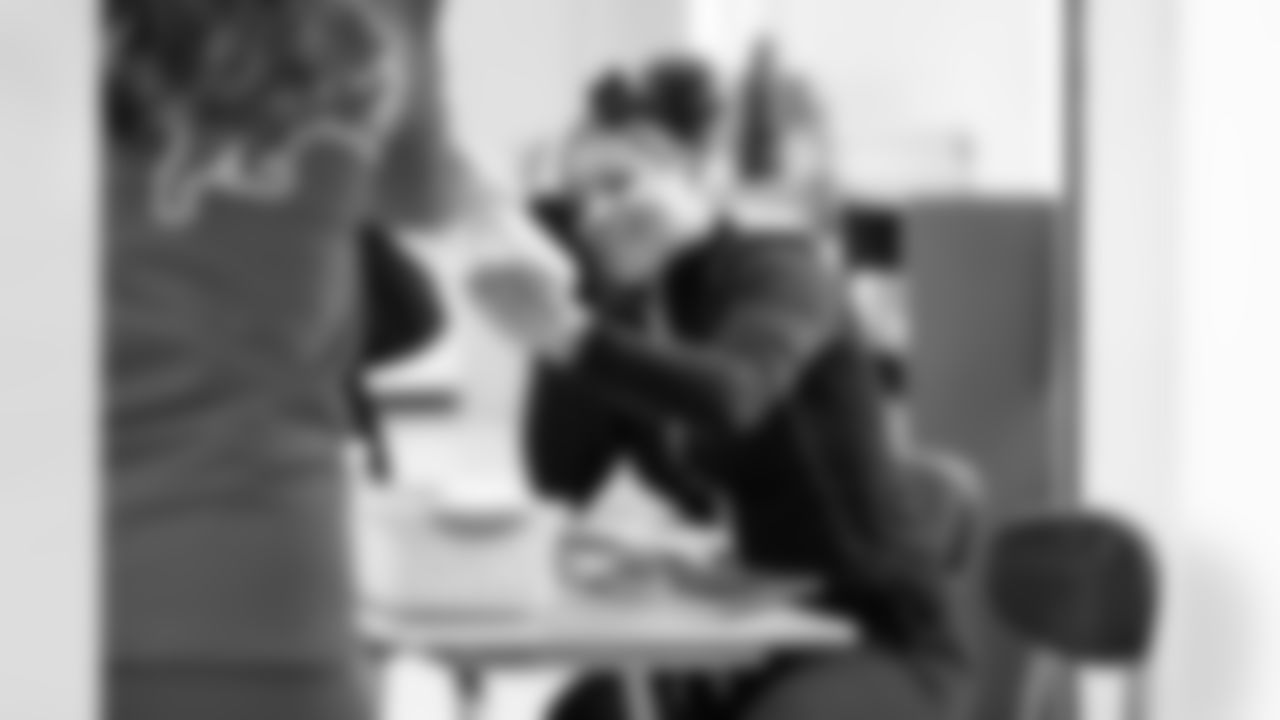 A student receiving a present from Detroit Lions Cheerleaders during the Presents from the Pride event at Detroit Lions Academy on Dec. 16, 2025 in Detroit. (Izzy Rincon/Detroit Lions)