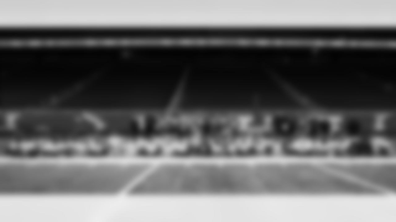 Participants, Detroit Lions runningback Jacob Saylors (25), Lions Legend Martell Webb, Detroit Lions wide receiver Tom Kennedy (85), Detroit Lions long snapper Hogan Hatten (49), Detroit Lions cornerback Rock Ya-Sin (23), Detroit Lions edge rusher Al-Quadin Muhammad (96), Detroit Lions cornerback Khalil Dorsey (30), Lions Legend Alex Lewis (59), Detroit Lions Mascot Roary and Detroit Lions Football Education Coaches pose for a photo during the Inspire Change Football Clinic at Ford Field on Dec. 9, 2025 in Detroit. (Izzy Rincon/Detroit Lions)