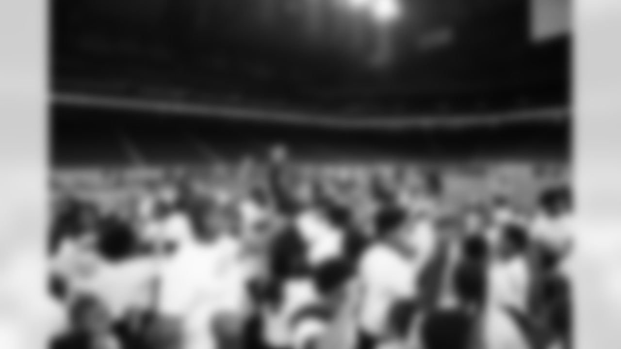 Detroit Lions Director of Football Education Chris Fritzsching and participants breaking it down during the Inspire Change Football Clinic at Ford Field on Dec. 9, 2025 in Detroit. (Izzy Rincon/Detroit Lions)