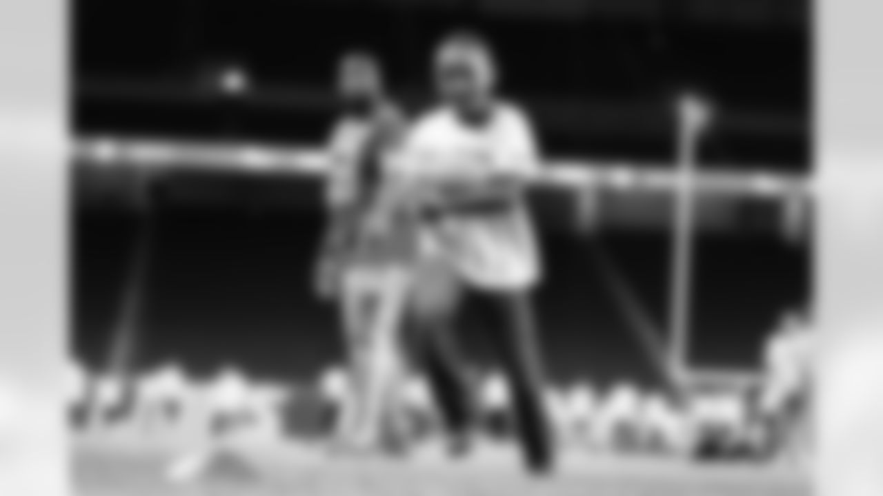 A participant running with a football during the Inspire Change Football Clinic at Ford Field on Dec. 9, 2025 in Detroit. (Izzy Rincon/Detroit Lions)