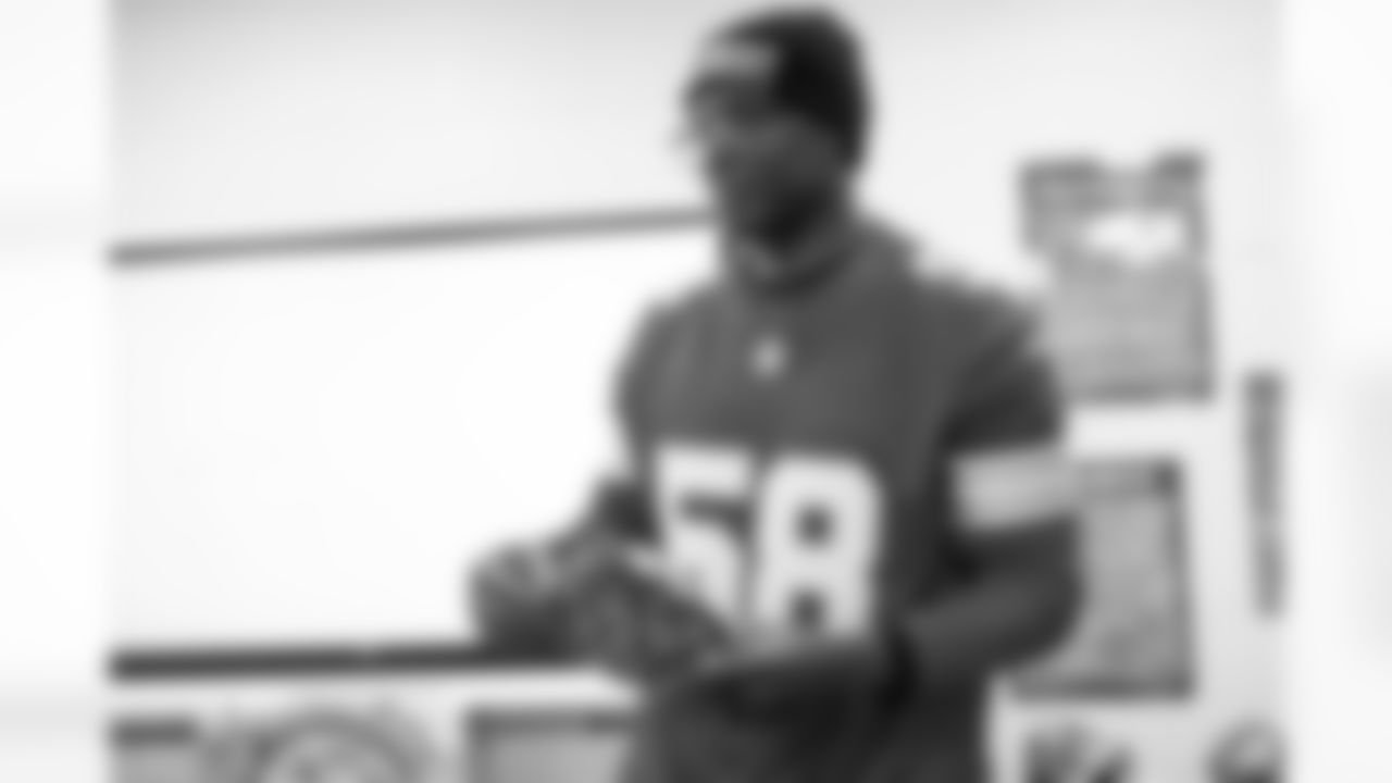 Lions Legend George Jamison (58) handing out presents during the Presents from the Pride event at Detroit Lions Academy on Dec. 16, 2025 in Detroit. (Izzy Rincon/Detroit Lions)