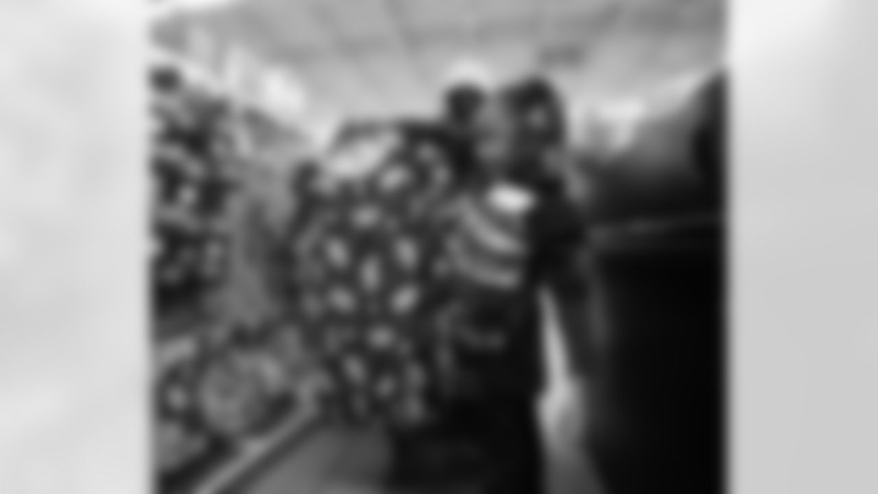 A participant loading items in the checkout line during Shop with a Lion at Meijer on Dec. 8, 2025 in Detroit. (Izzy Rincon/Detroit Lions)