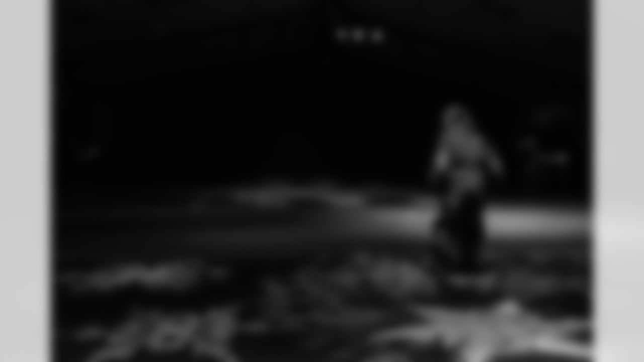 A Cub Club member dances on snowflakes during the Cub Club Wild Lights event at the Detroit Zoo on Dec. 10, 2025 in Royal Oak, Mich. (Stephanie VanWagoner/Detroit Lions)