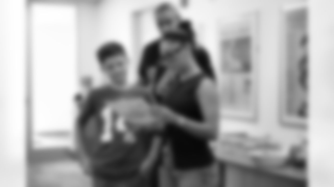 Brooklyn Adams of the St. Brown Foundation looks at a design with a student during a shoe design competition event at the Meijer Performance Center on Sept. 27, 2025 in Allen Park, Mich. (Carl Jones II/Detroit Lions via AP)