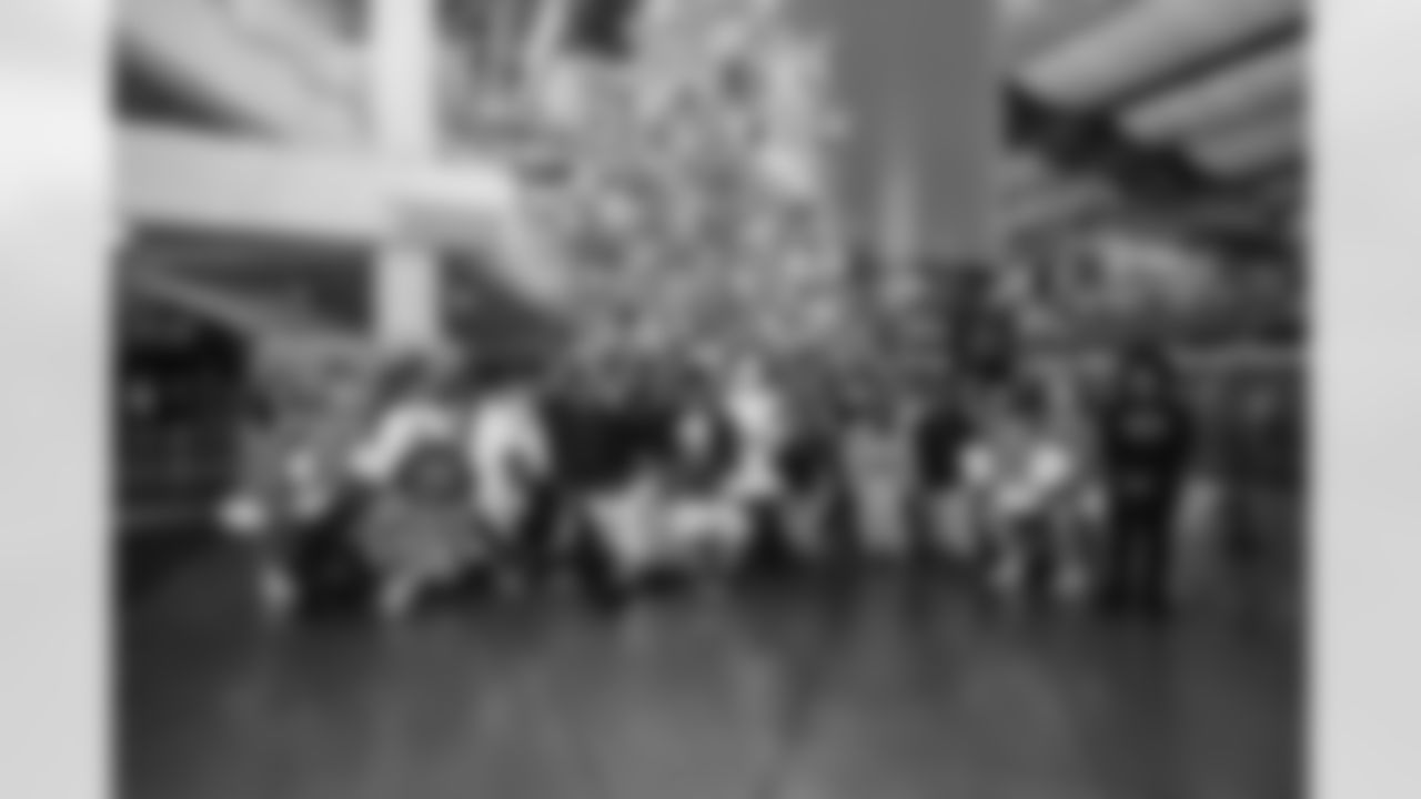 Santa, Detroit Lions Cheerleaders, Detroit Lions Mascot Roary, Lions Legend Tony Semple (62), Lions Legend Tim Walton (57), Lions Legend Jeff Chadwick (89) and DLA students during Presents from the Pride in Detroit at Ford Field on December 12, 2023 (Stephanie VanWagoner/Detroit Lions)