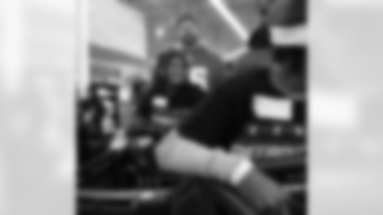 A participant smiling while pushing a shopping cart during Shop with a Lion at Meijer on Dec. 8, 2025 in Detroit. (Izzy Rincon/Detroit Lions)