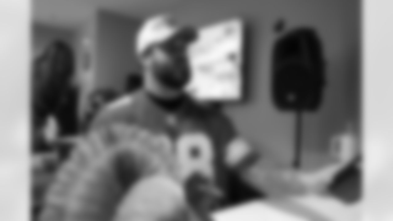 Detroit Lions tackle Taylor Decker (68) signing autographs during a Thanksgiving lunch event at Alternatives For Girls on Nov. 28, 2025 in Detroit. (Izzy Rincon/Detroit Lions)