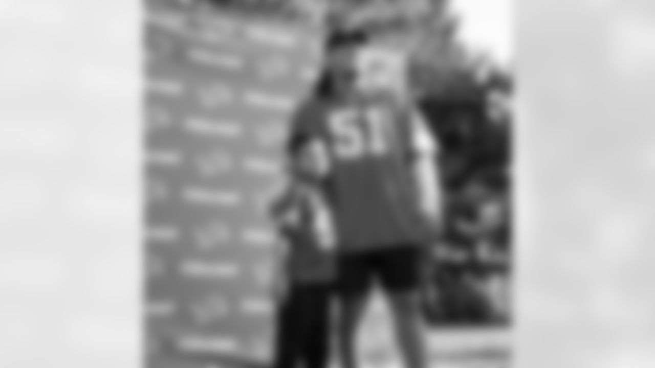 Detroit Lions defensive lineman Roy Lopez (51) and a fan pose for a group photo during the Kickoff on the Block event at The Springdale Green Lot on Sept. 12, 2025 in Detroit. (Izzy Rincon/Detroit Lions)