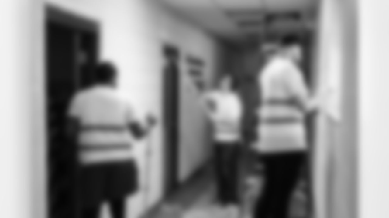 Volunteers paint a hallway during a spring cleanup event at the Delray Community Center on June 10, 2025 in Detroit. (Mike Ferdinande/Detroit Lions)