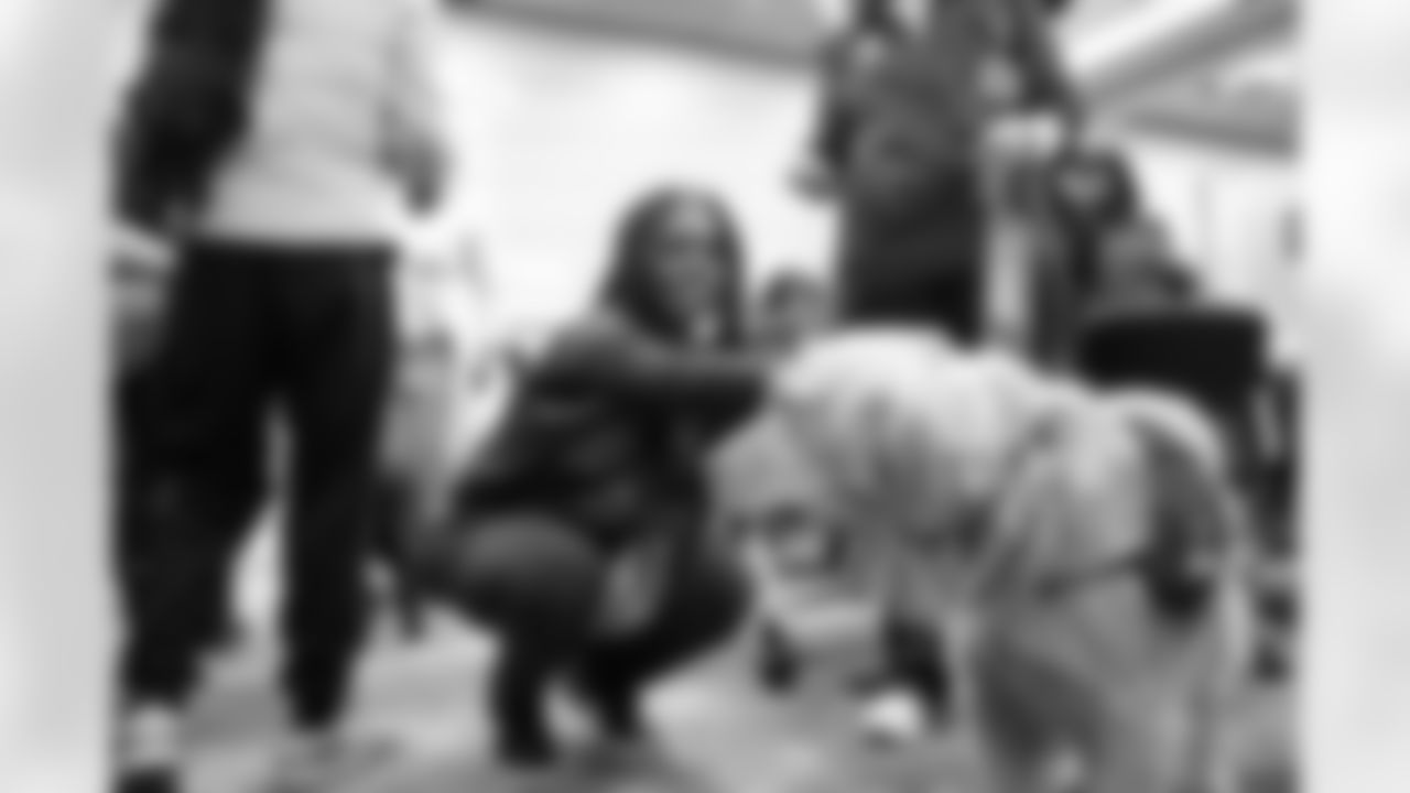 A student petting a service dog during a Detroit Lions Academy health and wellness field trip at the Henry Ford Health campus on Feb. 27, 2026 in Detroit. (Izzy Rincon/Detroit Lions)
