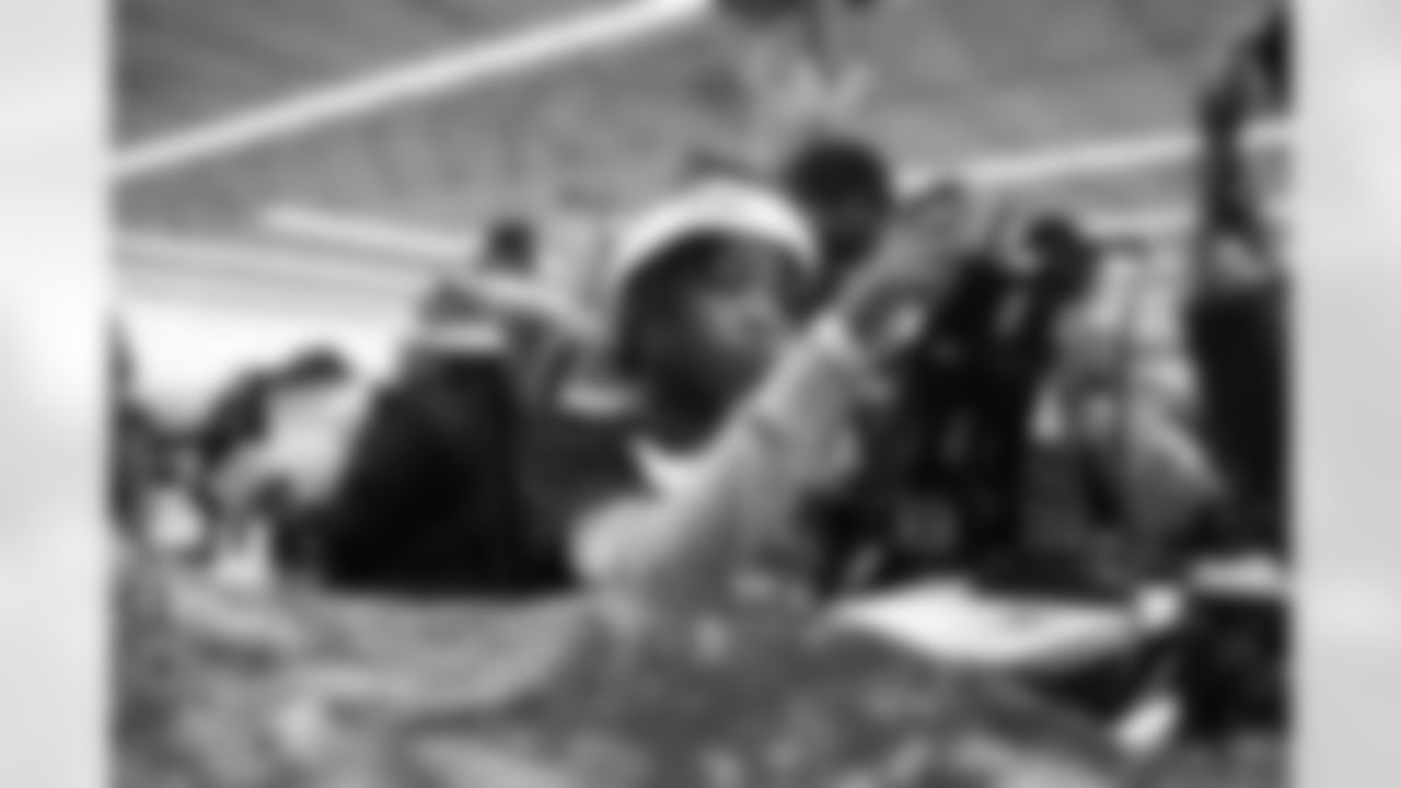 A participant swiping a Meijer gift card during Shop with a Lion at Meijer on Dec. 8, 2025 in Detroit. (Izzy Rincon/Detroit Lions)