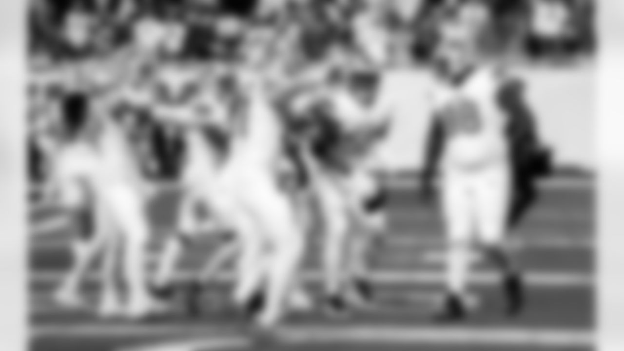 Detroit Lions edge rusher Aidan Hutchinson (97), Detroit Lions linebacker Derrick Barnes (55), and Detroit Lions defensive lineman DJ Reader (98) celebrate after an interception during an NFL football game against the Dallas Cowboys on Thursday, Dec. 4, 2025 in Detroit. (Jeff Nguyen/Detroit Lions via AP)