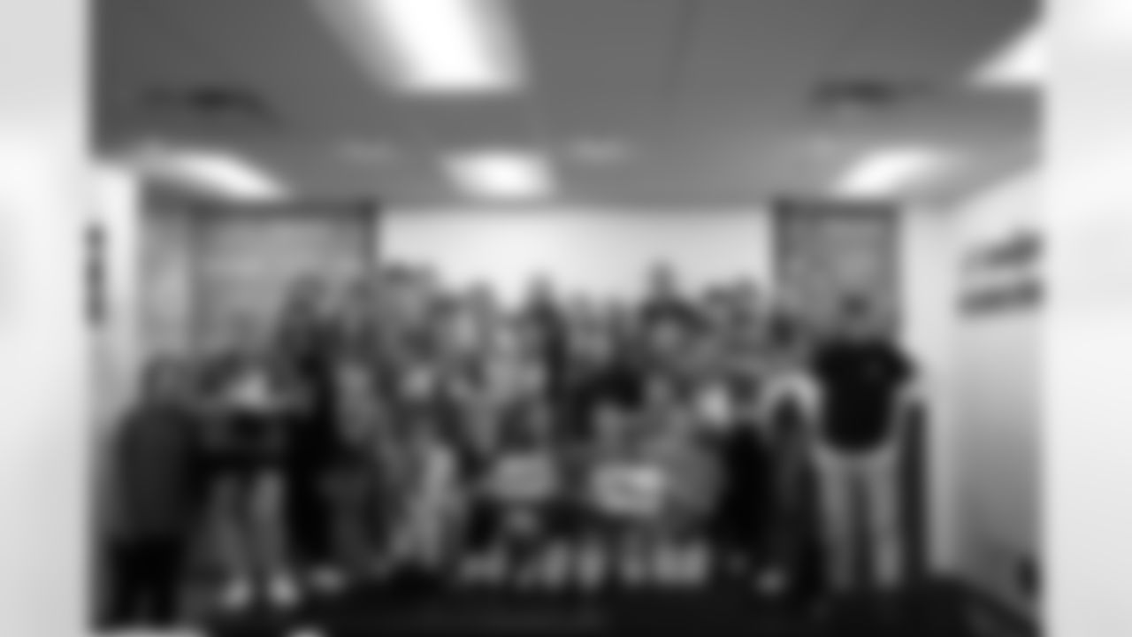 Detroit Lions wide receiver Amon-Ra St. Brown (14) takes a photo with students of the East Jordan Shoe Club during a shoe design competition event at the Meijer Performance Center on Sept. 27, 2025 in Allen Park, Mich. (Carl Jones II/Detroit Lions via AP)