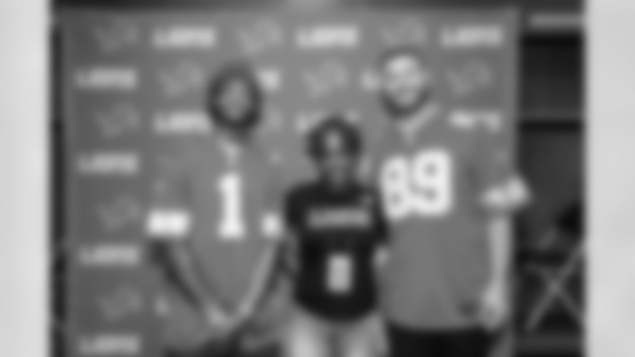 Detroit Lions wide receiver Jameson Williams (1) and Detroit Lions tight end Brock Wright (89) pose for a photo with a fan during the Detroit Lions Draft Party at Ford Field on April 24, 2025 in Detroit. (Stephanie VanWagoner/Detroit Lions)