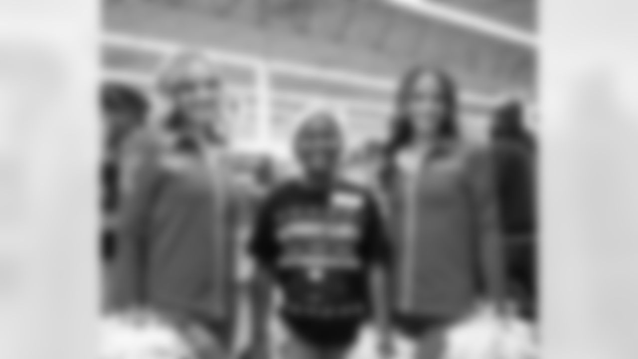 A participant and Detroit Lions Cheerleaders pose for a photo during Shop with a Lion at Meijer on Dec. 8, 2025 in Detroit. (Izzy Rincon/Detroit Lions)