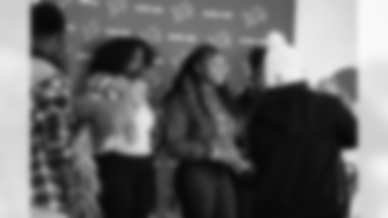 Students smiling in the photobooth during the Presents from the Pride event at Detroit Lions Academy on Dec. 16, 2025 in Detroit. (Izzy Rincon/Detroit Lions)