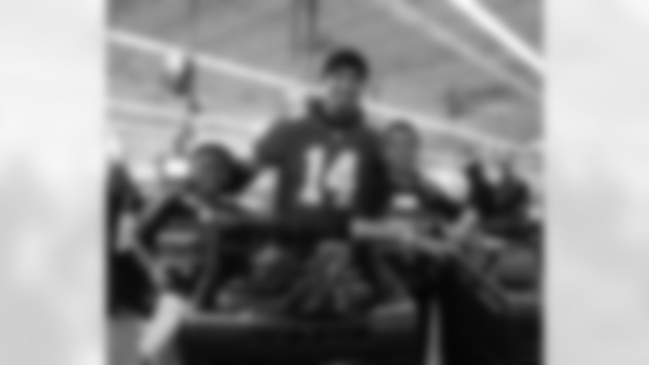 Detroit Lions wide receiver Amon-Ra St. Brown (14) and participants pose for a group photo during Shop with a Lion at Meijer on Dec. 8, 2025 in Detroit. (Izzy Rincon/Detroit Lions)