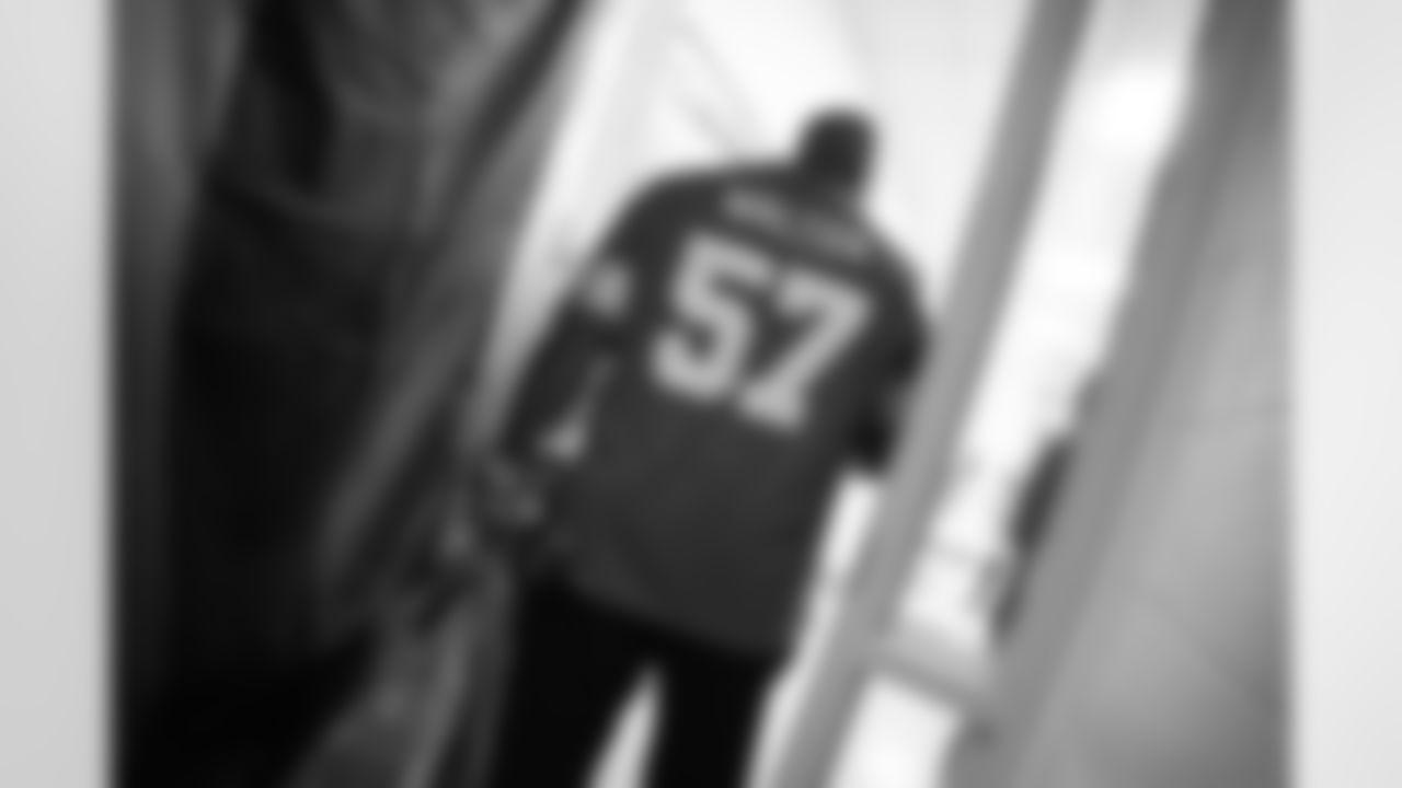 Lions Legend Tim Walton (57) carrying gifts during the Presents from the Pride event at Detroit Lions Academy on Dec. 16, 2025 in Detroit. (Izzy Rincon/Detroit Lions)