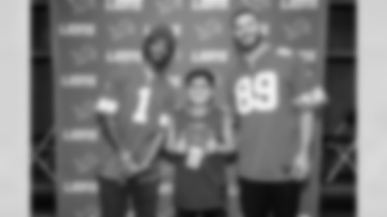 Detroit Lions wide receiver Jameson Williams (1) and Detroit Lions tight end Brock Wright (89) pose for a photo with a fan during the Detroit Lions Draft Party at Ford Field on April 24, 2025 in Detroit. (Stephanie VanWagoner/Detroit Lions)