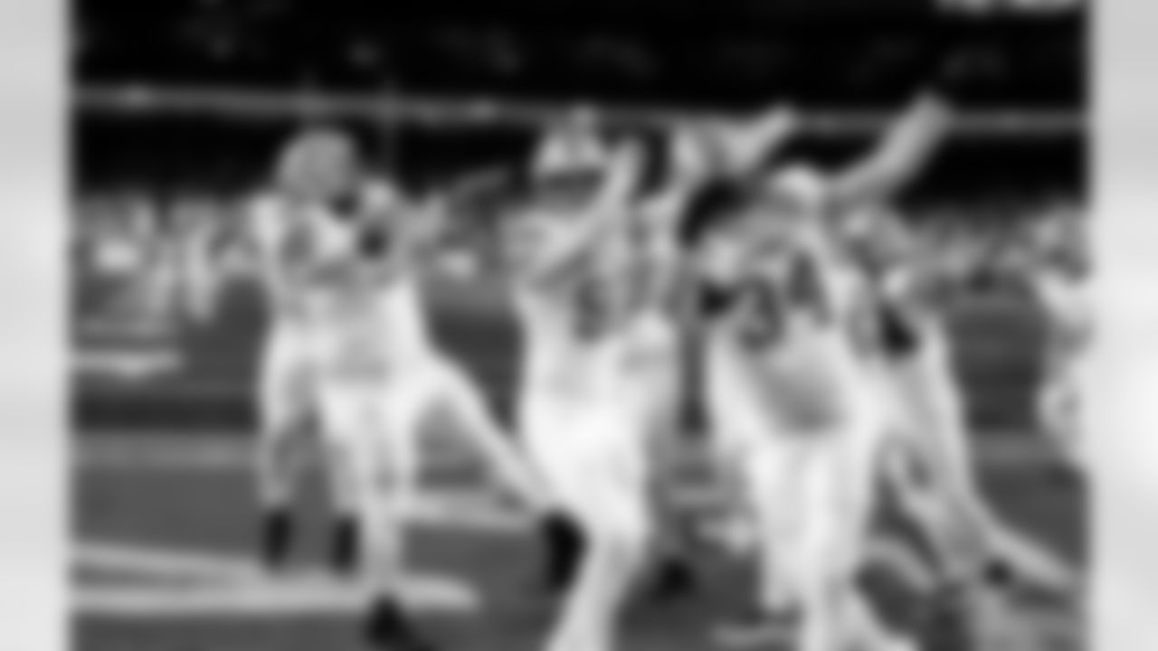 /Detroit Lions defensive lineman Tyleik Williams (91), Detroit Lions edge rusher Aidan Hutchinson (97), and Detroit Lions linebacker Alex Anzalone (34) celebrate after Detroit Lions linebacker Derrick Barnes (55) intercepts a pass during an NFL football game against the Dallas Cowboys on Thursday, Dec. 4, 2025 in Detroit. (Jeff Nguyen/Detroit Lions via AP)