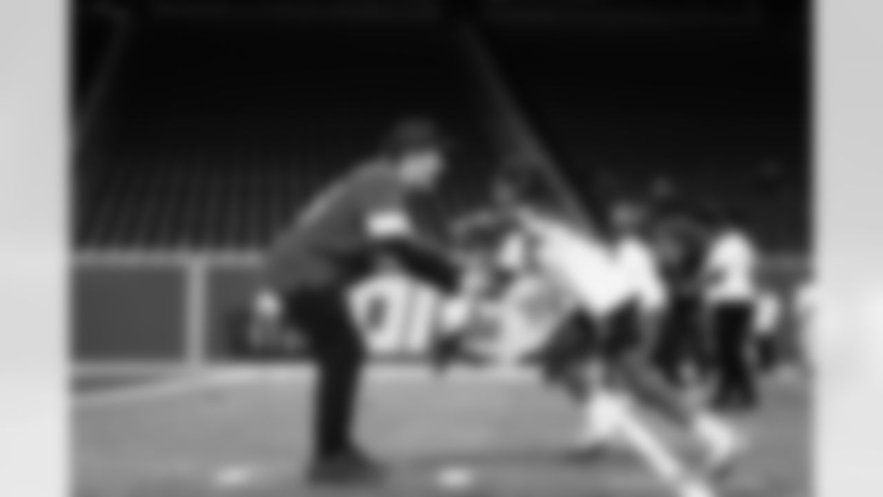 Detroit Lions wide receiver Tom Kennedy (85) and a participant doing a drill at the running back station during the Inspire Change Football Clinic at Ford Field on Dec. 9, 2025 in Detroit. (Izzy Rincon/Detroit Lions)