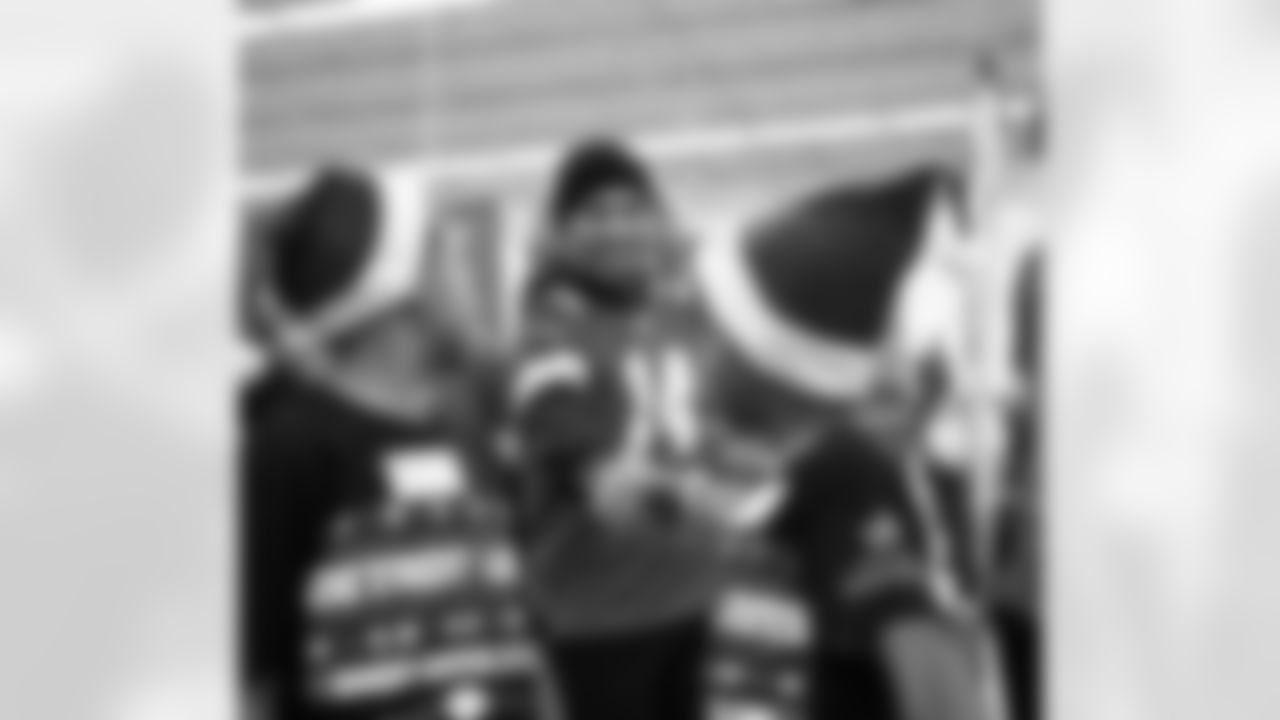 Detroit Lions wide receiver Amon-Ra St. Brown (14) shaking hands with a participant during Shop with a Lion at Meijer on Dec. 8, 2025 in Detroit. (Izzy Rincon/Detroit Lions)