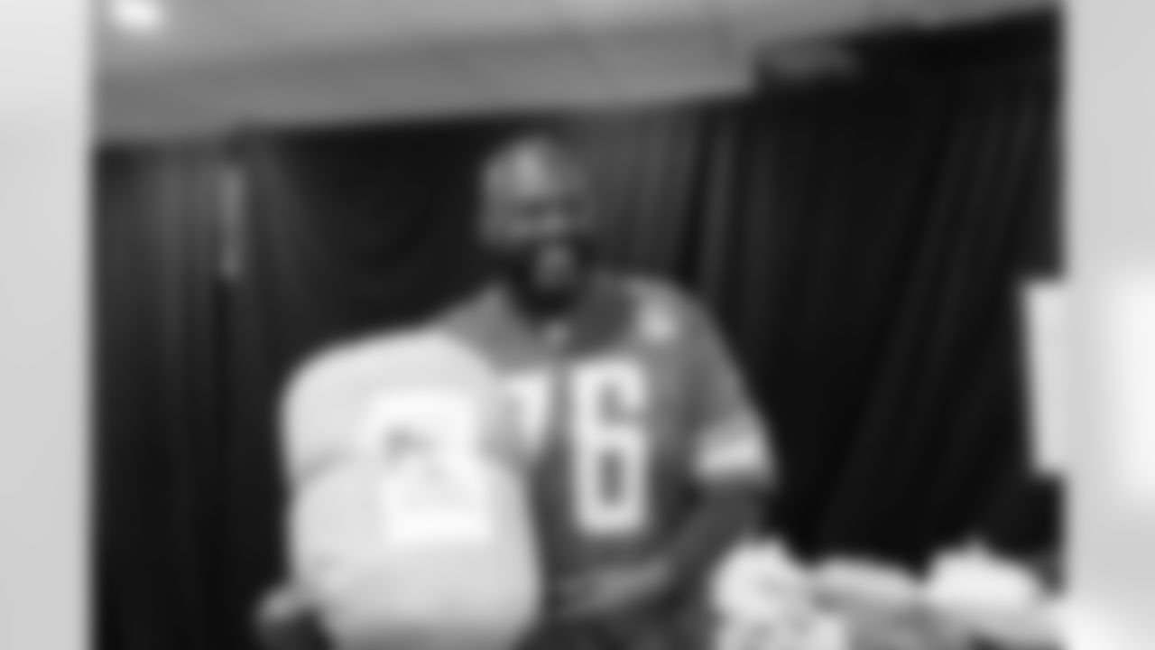 Lions Legend Scott Conover (76) handing out presents during Presents from the Pride in Detroit at Ford Field on December 12, 2023 (Stephanie VanWagoner/Detroit Lions)