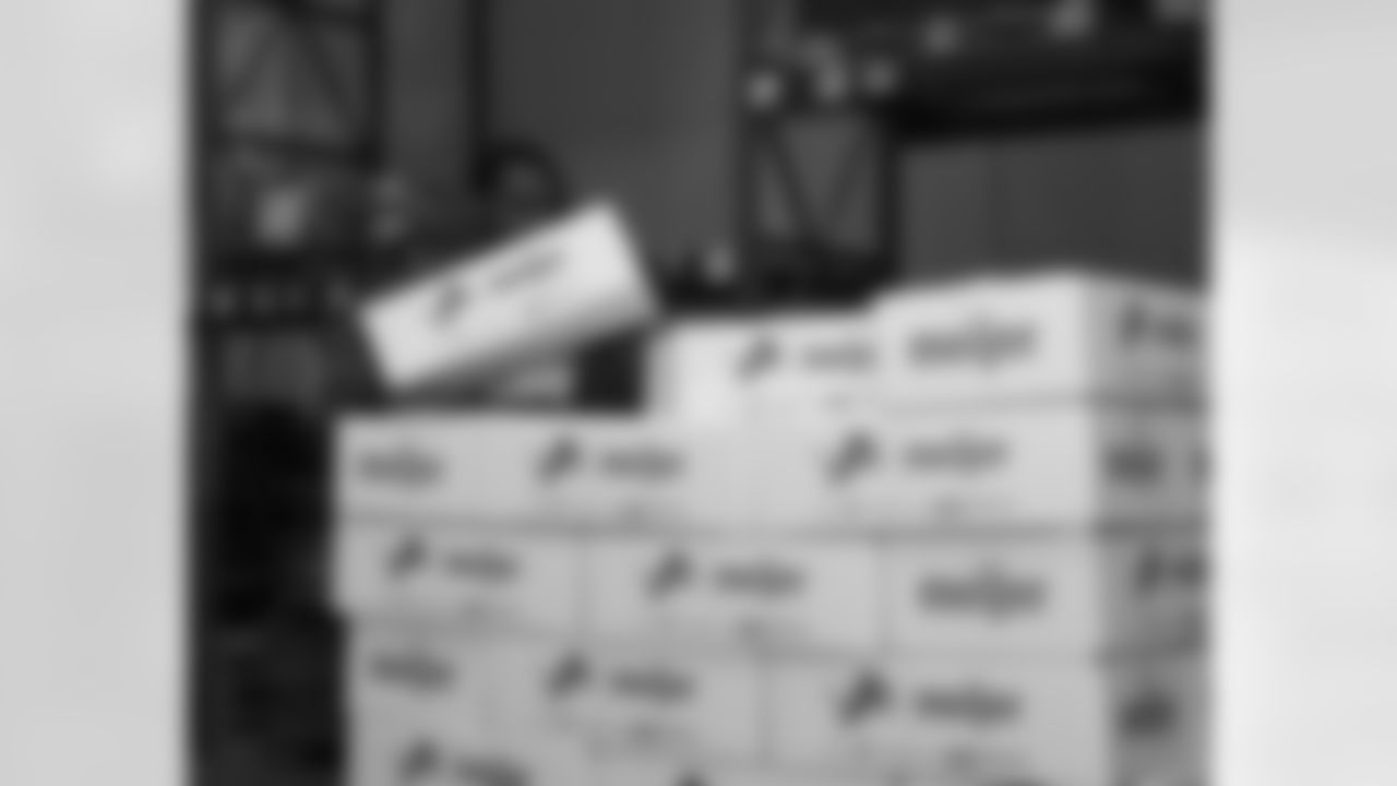 A National Guard member stacking boxes during a Thanksgiving meal packing event at Gleaners Community Food Bank on Oct. 27, 2025 in Taylor, Mich. (Izzy Rincon/Detroit Lions)