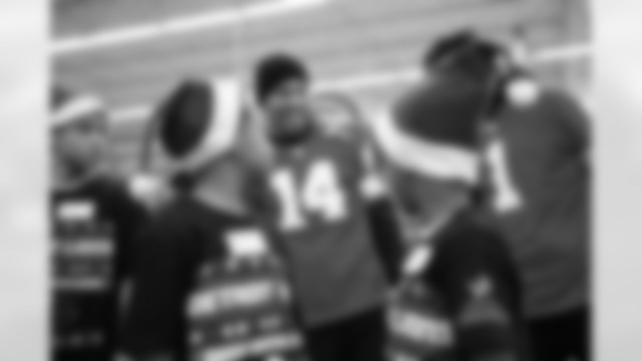 Detroit Lions wide receiver Amon-Ra St. Brown (14) talking and smiling with participants during Shop with a Lion at Meijer on Dec. 8, 2025 in Detroit. (Izzy Rincon/Detroit Lions)