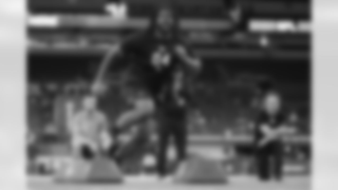 Michigan defensive lineman Rayshaun Benny (04) runs a drill at the NFL football scouting combine in Indianapolis, Thursday, Feb. 26, 2026. (AP Photo/Michael Conroy)