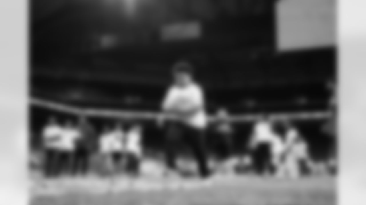 A participant running with a football during the Inspire Change Football Clinic at Ford Field on Dec. 9, 2025 in Detroit. (Izzy Rincon/Detroit Lions)