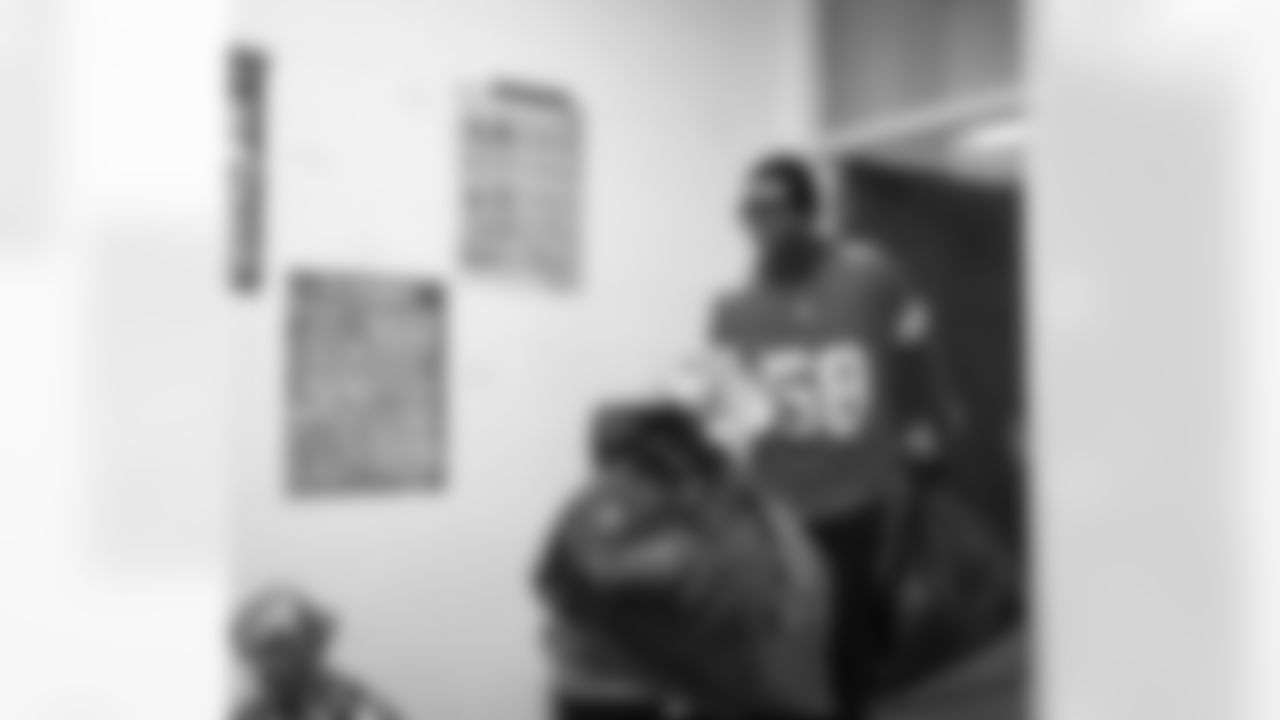 Lions Legend George Jamison (58) walking with presents in hand during the Presents from the Pride event at Detroit Lions Academy on Dec. 16, 2025 in Detroit. (Izzy Rincon/Detroit Lions)