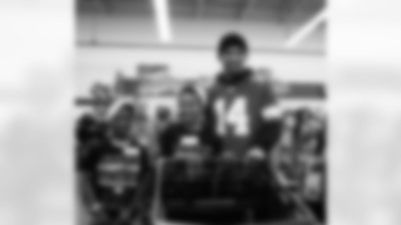 Detroit Lions wide receiver Amon-Ra St. Brown (14) and participants heading to go shop during Shop with a Lion at Meijer on Dec. 8, 2025 in Detroit. (Izzy Rincon/Detroit Lions)