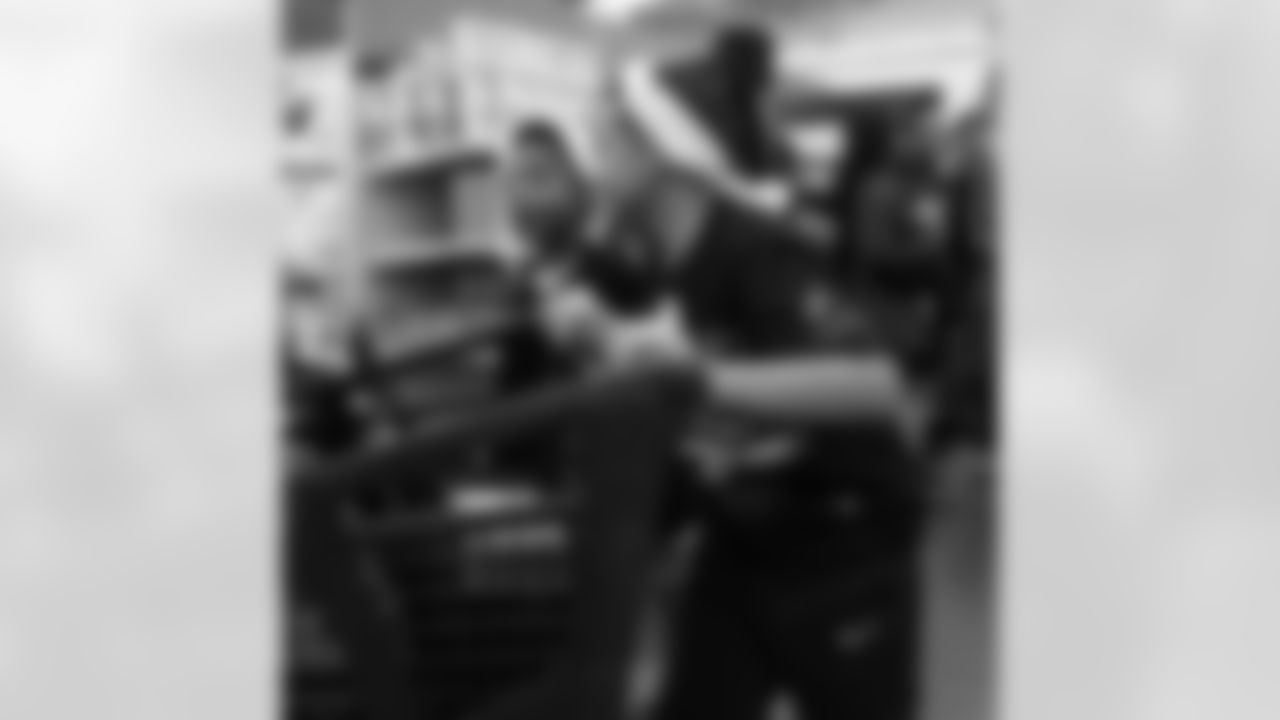 Participants pushing a cart around the store during Shop with a Lion at Meijer on Dec. 8, 2025 in Detroit. (Izzy Rincon/Detroit Lions)