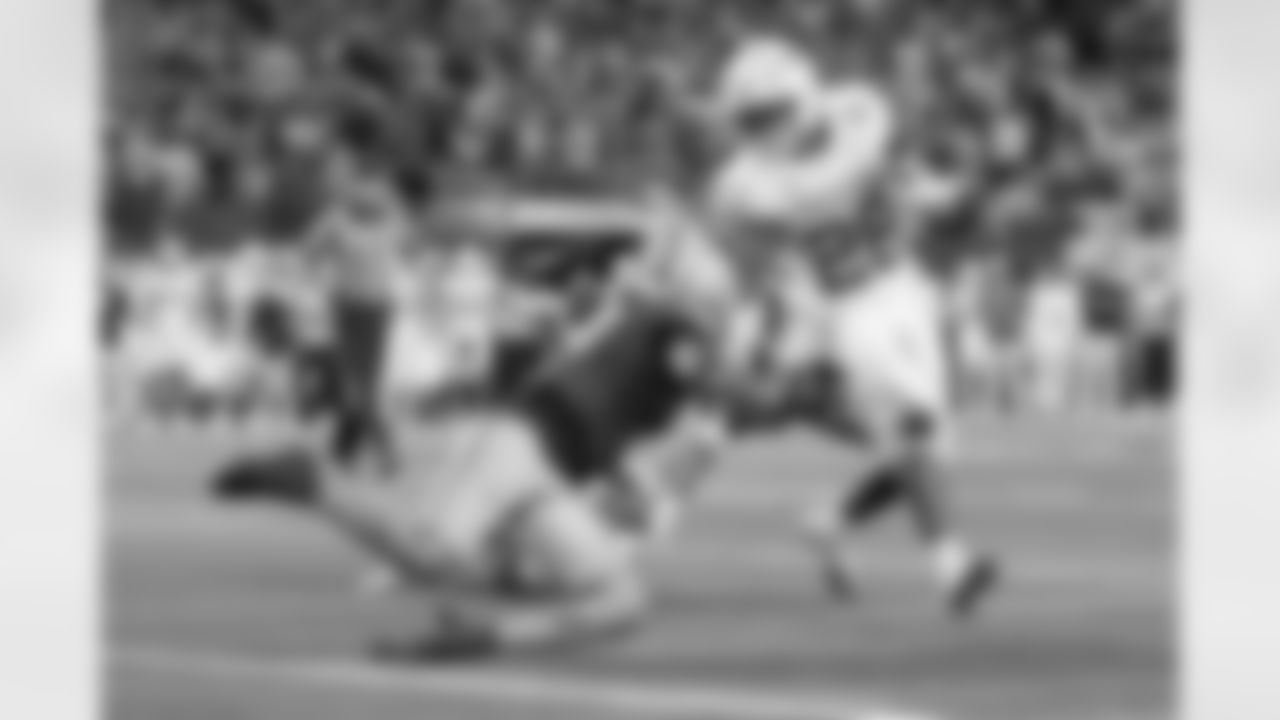 Texas running back Quintrevion Wisner (26) is brought down by Ohio State safety Lathan Ransom, left, during the Cotton Bowl College Football Playoff semifinal game, Friday, Jan. 10, 2025, in Arlington, Texas. (AP Photo/Gareth Patterson)