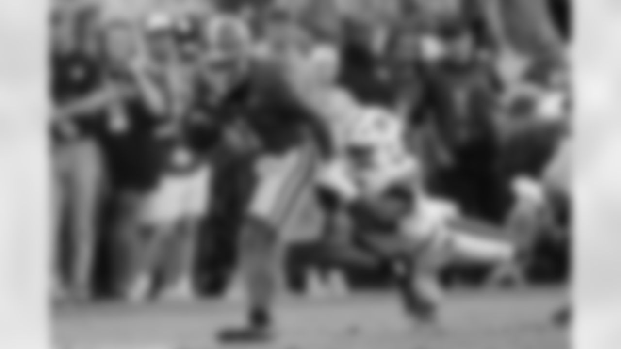 Georgia running back Trevor Etienne (1) tries to escape from Auburn linebacker Demarcus Riddick (16) after making a catch in the second half of an NCAA college football game Saturday, Oct. 5, 2024, in Athens, Ga. (AP Photo/John Bazemore)