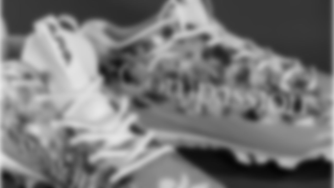 Christian Elliss's cleats supporting Compassion International Inc.