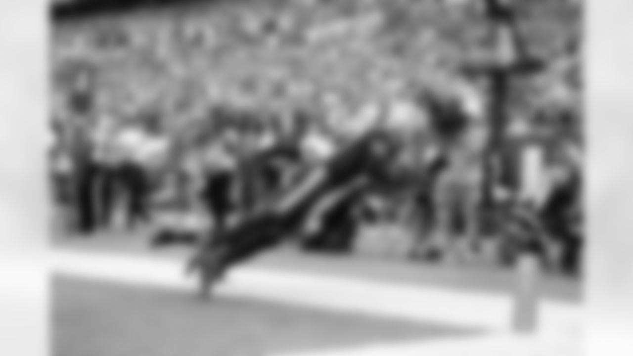 Stefon Diggs catches a 1-yard pass from Drake Maye to score a touchdown in the second quarter.