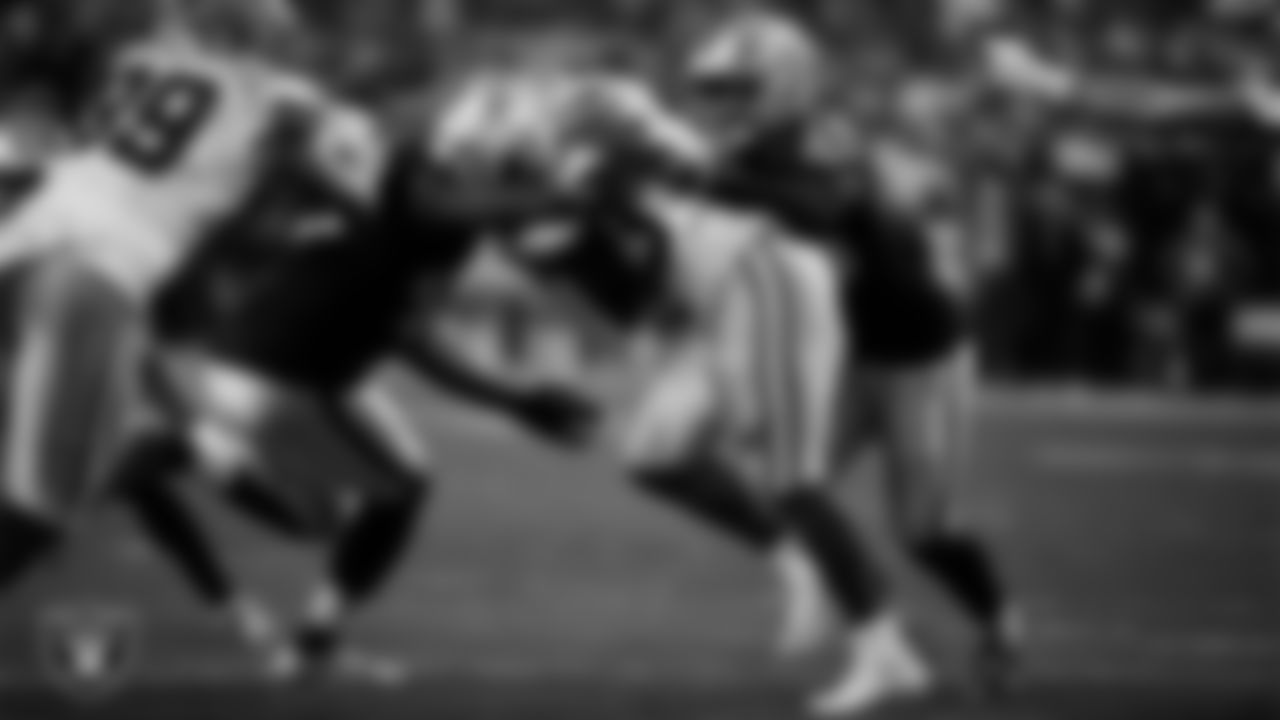 Las Vegas Raiders linebacker Jamin Davis (48) and linebacker Devin White (45) make a tackle during the regular season home game against the Dallas Cowboys at Allegiant Stadium.