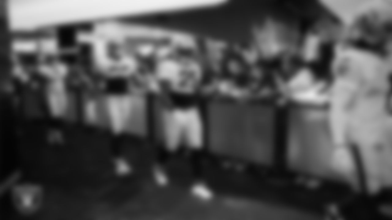 The Las Vegas Raiders walk down the tunnel and interact with fans before a 2025 Training Camp mock game at Allegiant Stadium.